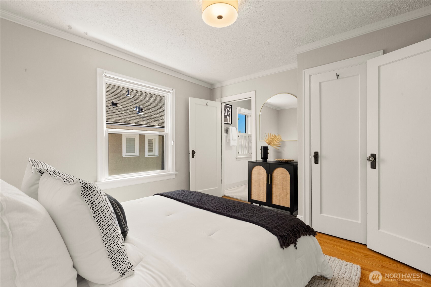 3617 East Cherry Street Seattle, WA 98122 - Photo 18 of 34 a bedroom with a bed and a painting on the wall