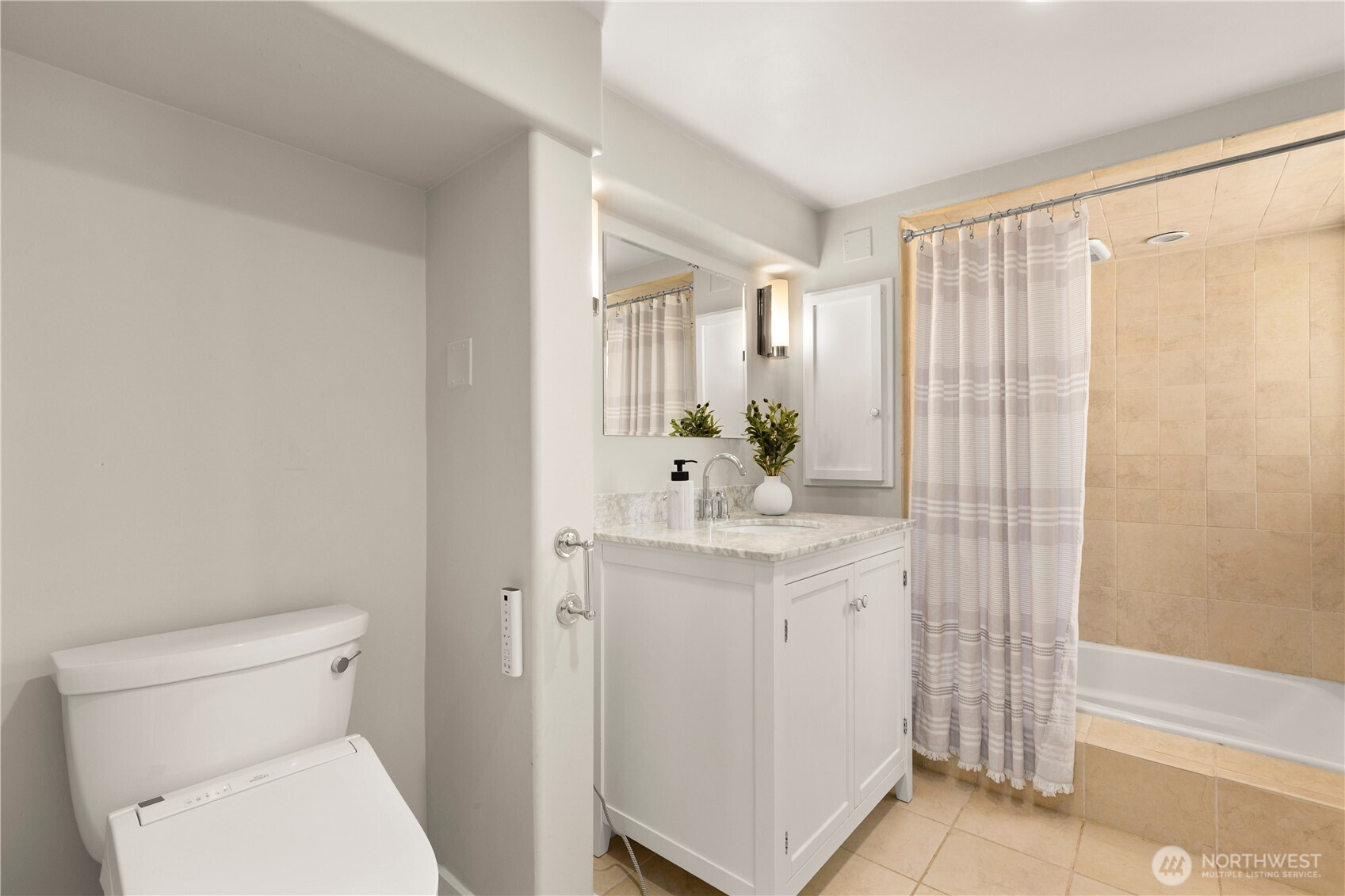 3617 East Cherry Street Seattle, WA 98122 - Photo 28 of 34 a bathroom with a sink a toilet and shower curtain
