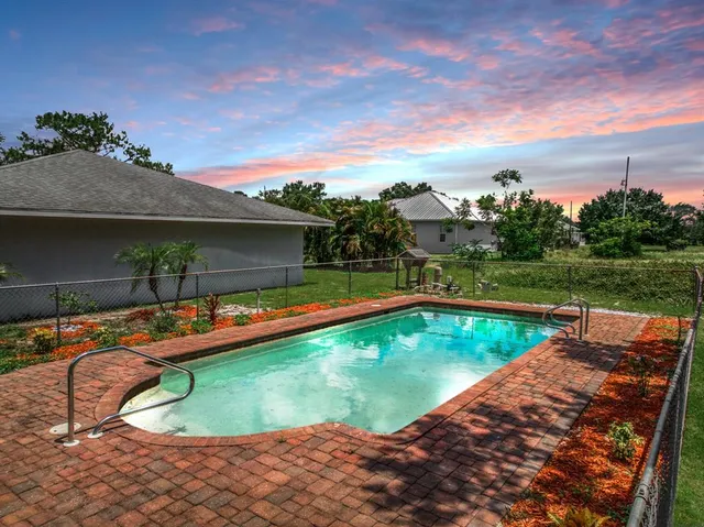 a view of swimming pool with seating area and roof