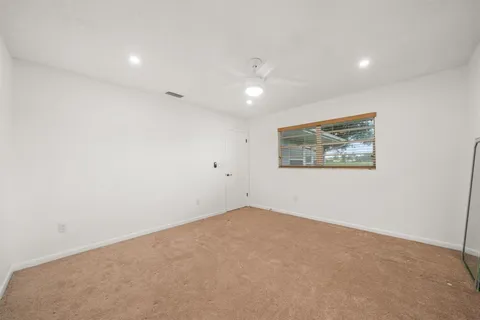 an empty room with a painting on the wall