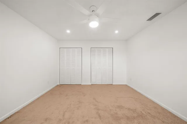 an empty room with a painting on the wall