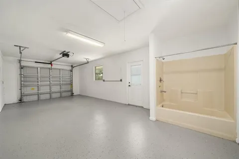 a kitchen with a sink a stove cabinets counter space and a window