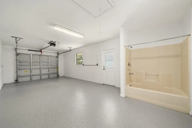 a kitchen with a sink a stove cabinets counter space and a window