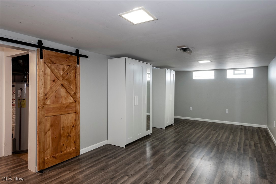 767 Glenhurst Road Willowick, OH 44095 - Photo 32 of 42 Basement featuring dark wood-type flooring and a barn door