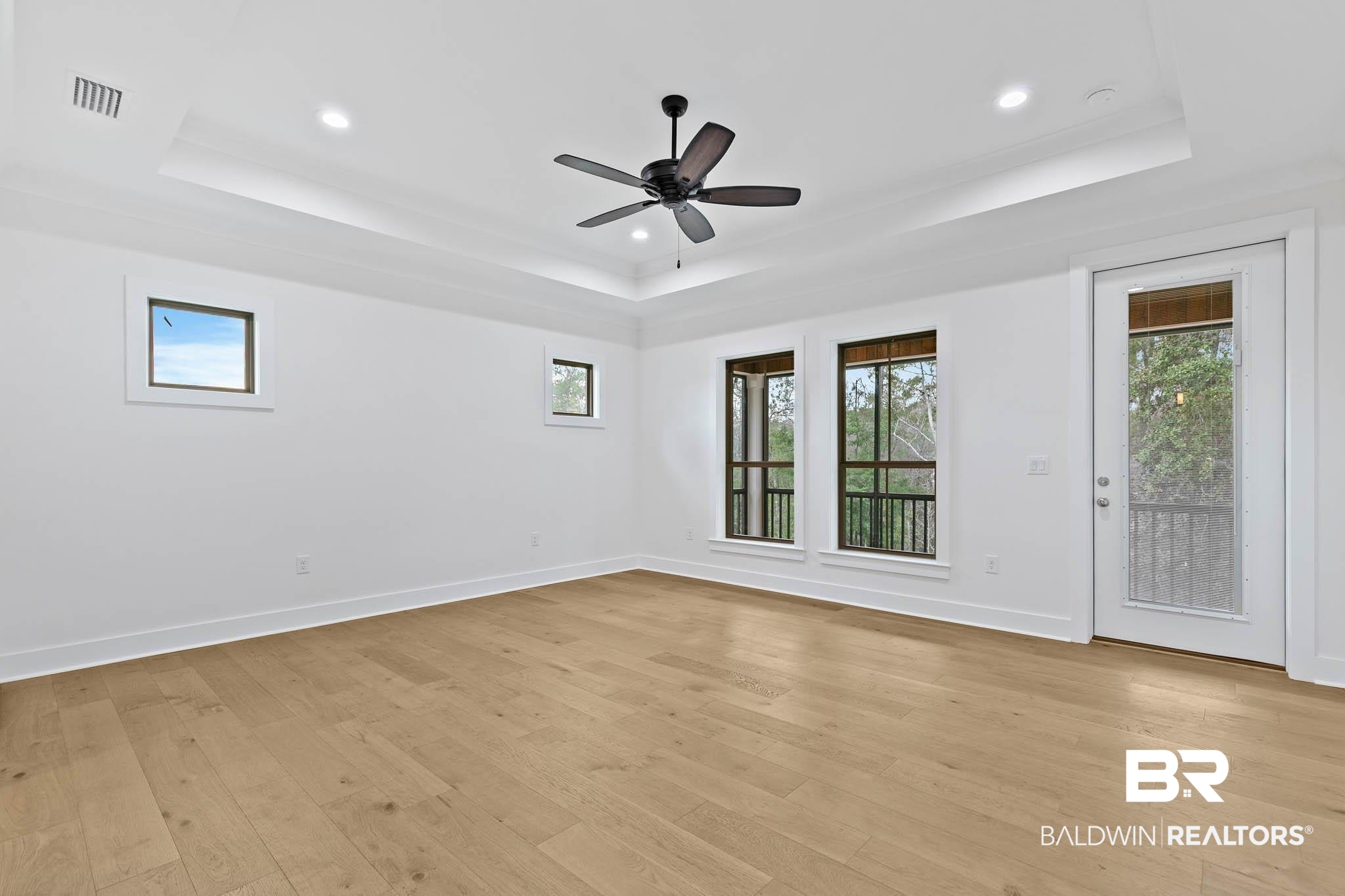 6656 Garrison Drive Daphne, AL 36527 - Photo 24 of 57 Spare room featuring light wood finished floors, plenty of natural light, a raised ceiling, and recessed lighting
