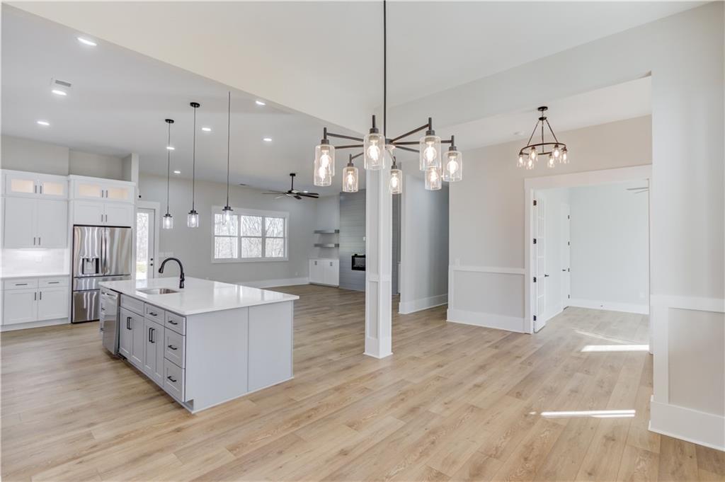 30 River Overlook Way Jefferson, GA 30549 - Photo 14 of 66 a kitchen with stainless steel appliances granite countertop a refrigerator a sink dishwasher and a wooden cabinets