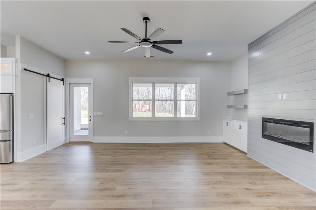 30 River Overlook Way Jefferson, GA 30549 - Photo 16 of 66 a view of an empty room with a window and wooden floor