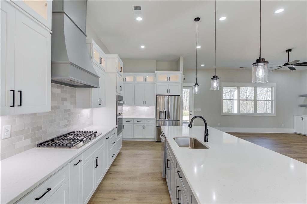 30 River Overlook Way Jefferson, GA 30549 - Photo 24 of 66 a kitchen with kitchen island a sink appliances and a counter top space