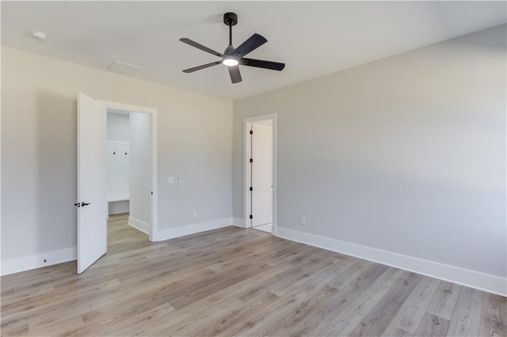 30 River Overlook Way Jefferson, GA 30549 - Photo 29 of 66 an empty room with wooden floor and ceiling fan
