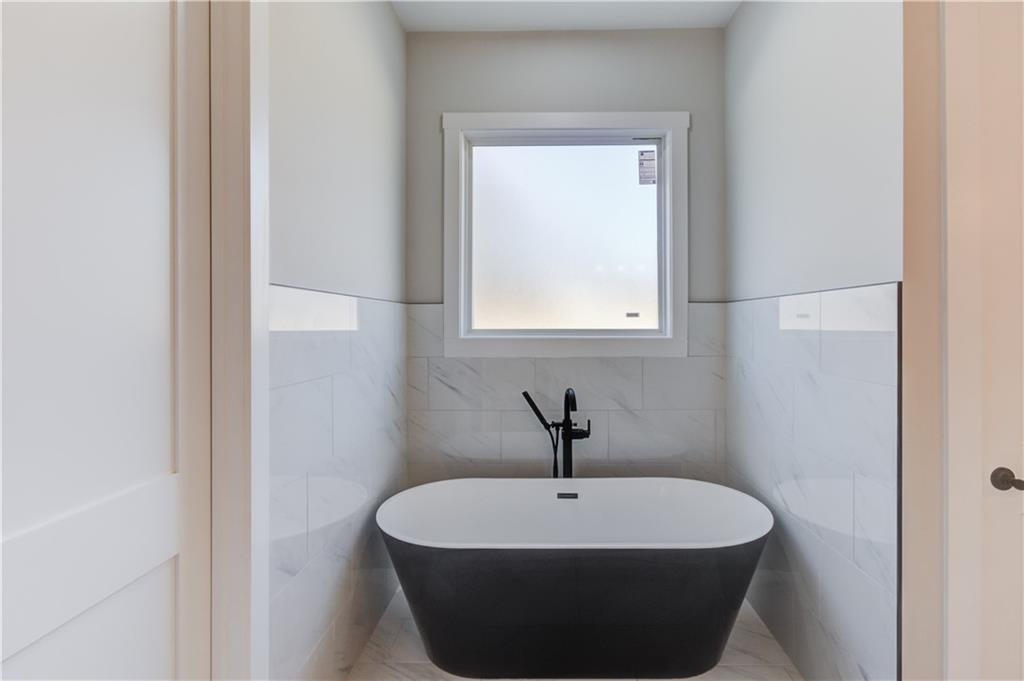 30 River Overlook Way Jefferson, GA 30549 - Photo 32 of 66 a white bath tub sitting in a bathroom