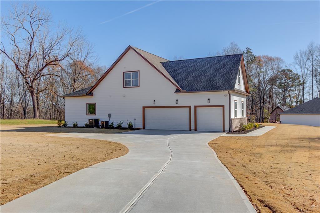30 River Overlook Way Jefferson, GA 30549 - Photo 6 of 66 a view of a house with snow on the road