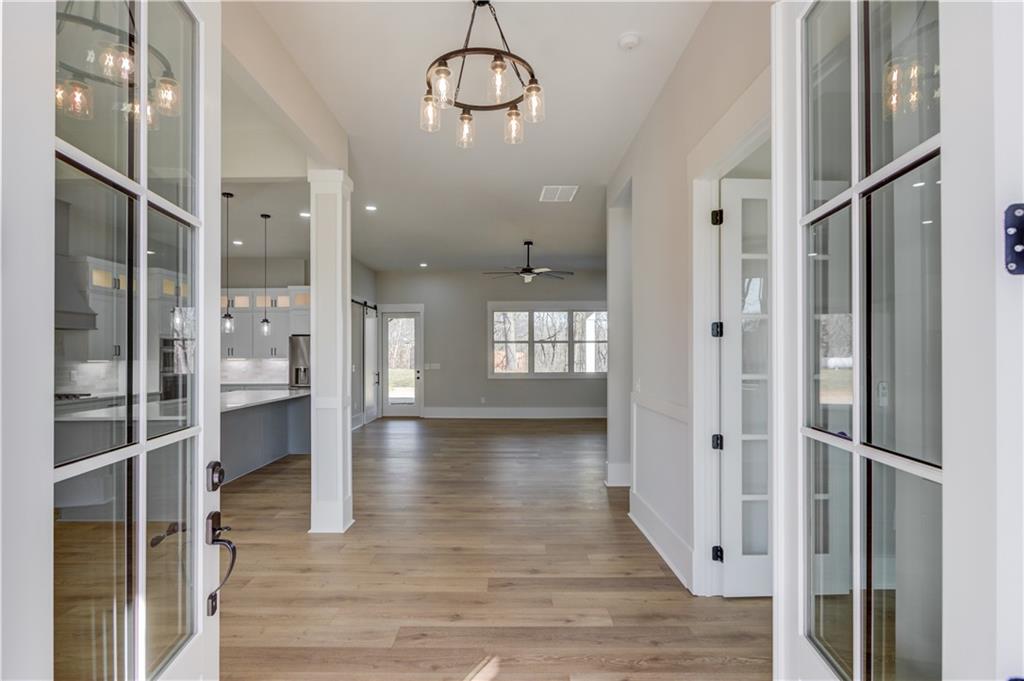 30 River Overlook Way Jefferson, GA 30549 - Photo 9 of 66 a view of a hallway with wooden floor and a kitchen