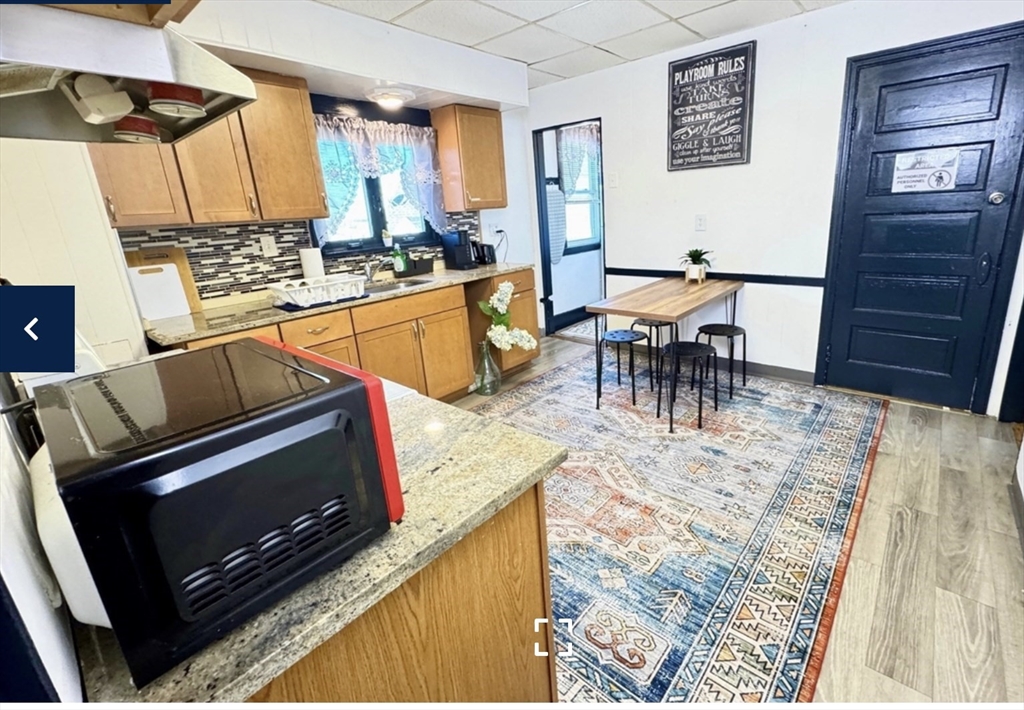 1656 North Shore Road, Unit 1 Revere, MA 02151 - Photo 11 of 18 a kitchen with a stove and a microwave