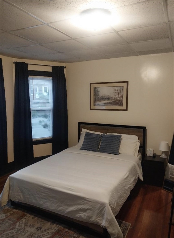 1656 North Shore Road, Unit 1 Revere, MA 02151 - Photo 16 of 18 a bedroom with a bed and a painting on the wall