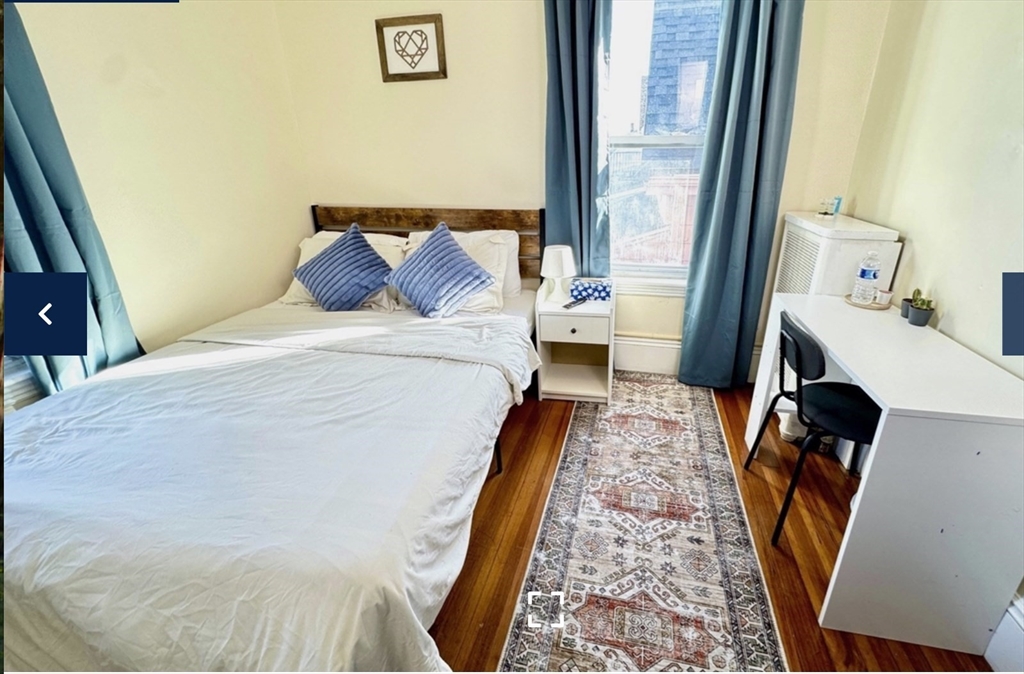 1656 North Shore Road, Unit 1 Revere, MA 02151 - Photo 4 of 18 a bed in a bedroom next to a window