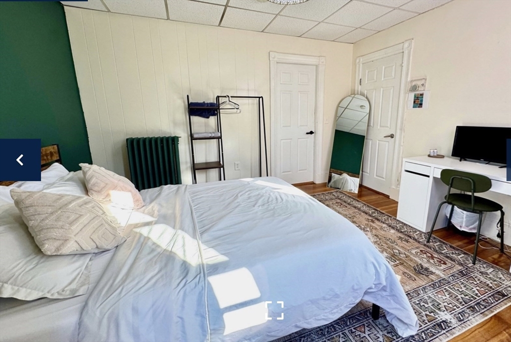1656 North Shore Road, Unit 1 Revere, MA 02151 - Photo 6 of 18 a bedroom with a bed and a desk