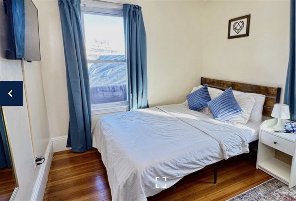 1656 North Shore Road, Unit 1 Revere, MA 02151 - Photo 8 of 18 a bedroom with a bed and a window