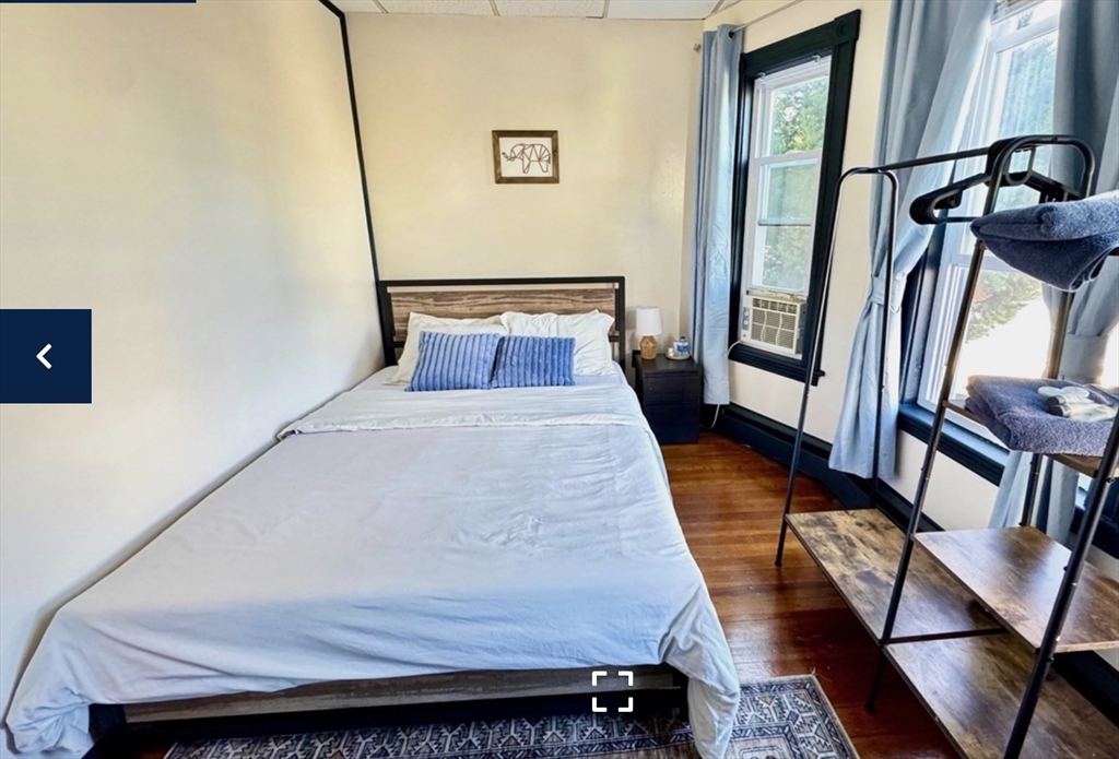 1656 North Shore Road, Unit 1 Revere, MA 02151 - Photo 9 of 18 a bedroom with a bed and wooden floor