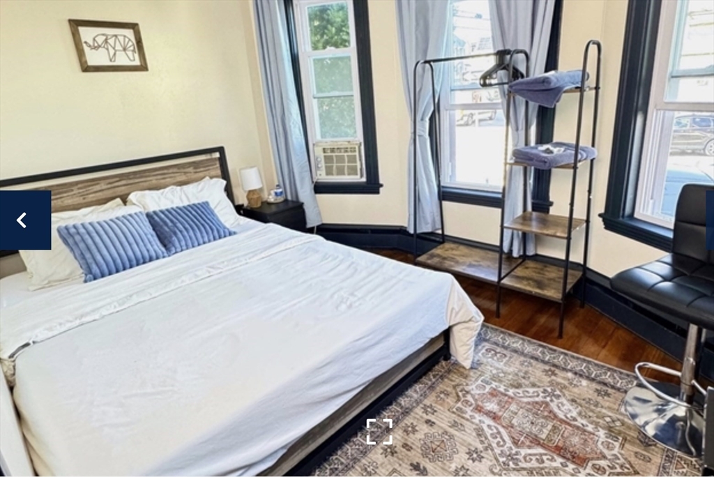 1656 North Shore Road, Unit 1 Revere, MA 02151 - Photo 10 of 18 a bedroom with a bed wooden floor and a window