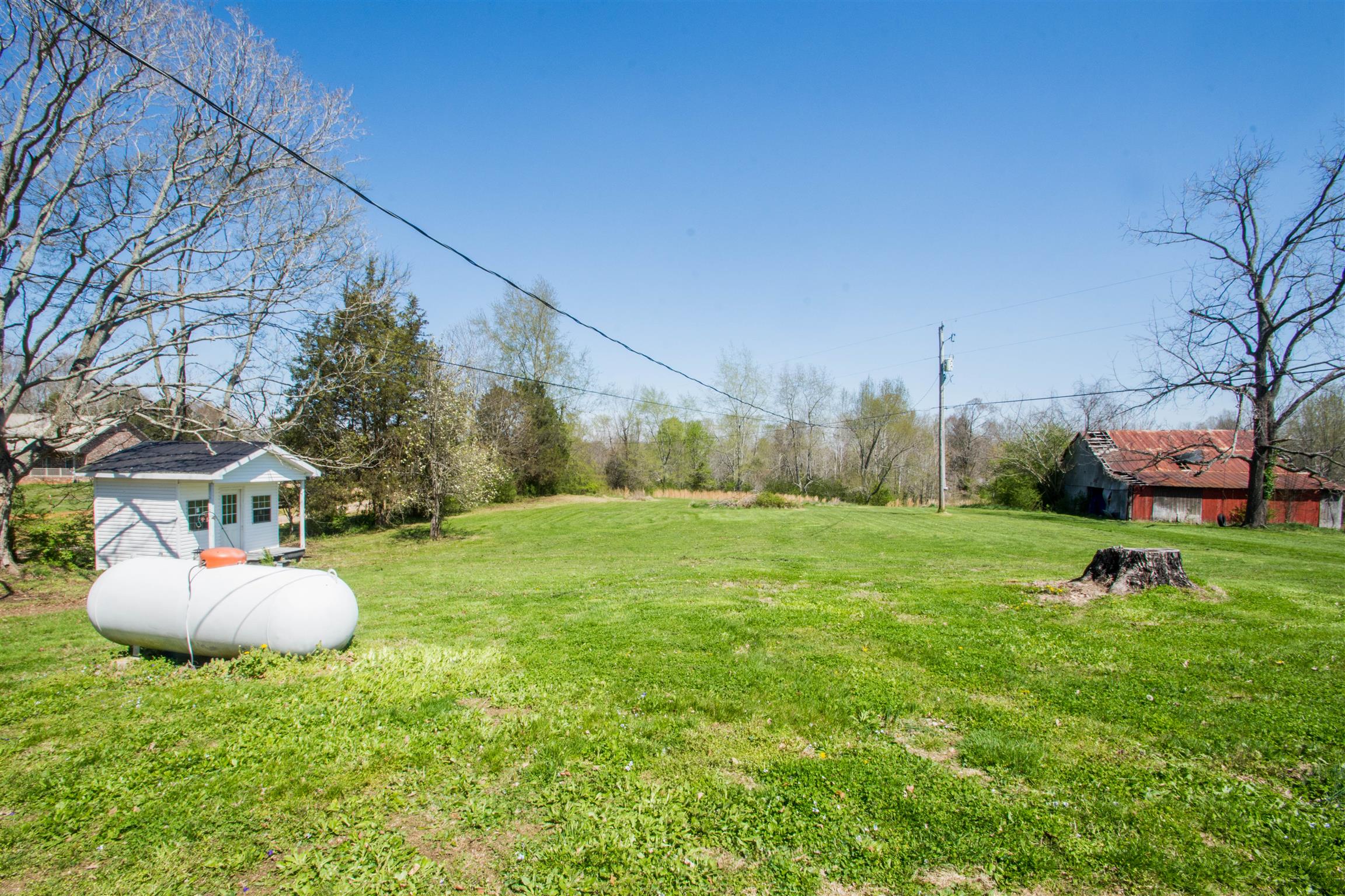 1810 Bend Road Clarksville, TN 37040 - Photo 16 of 17 a backyard of a house with table and chairs plants and large trees