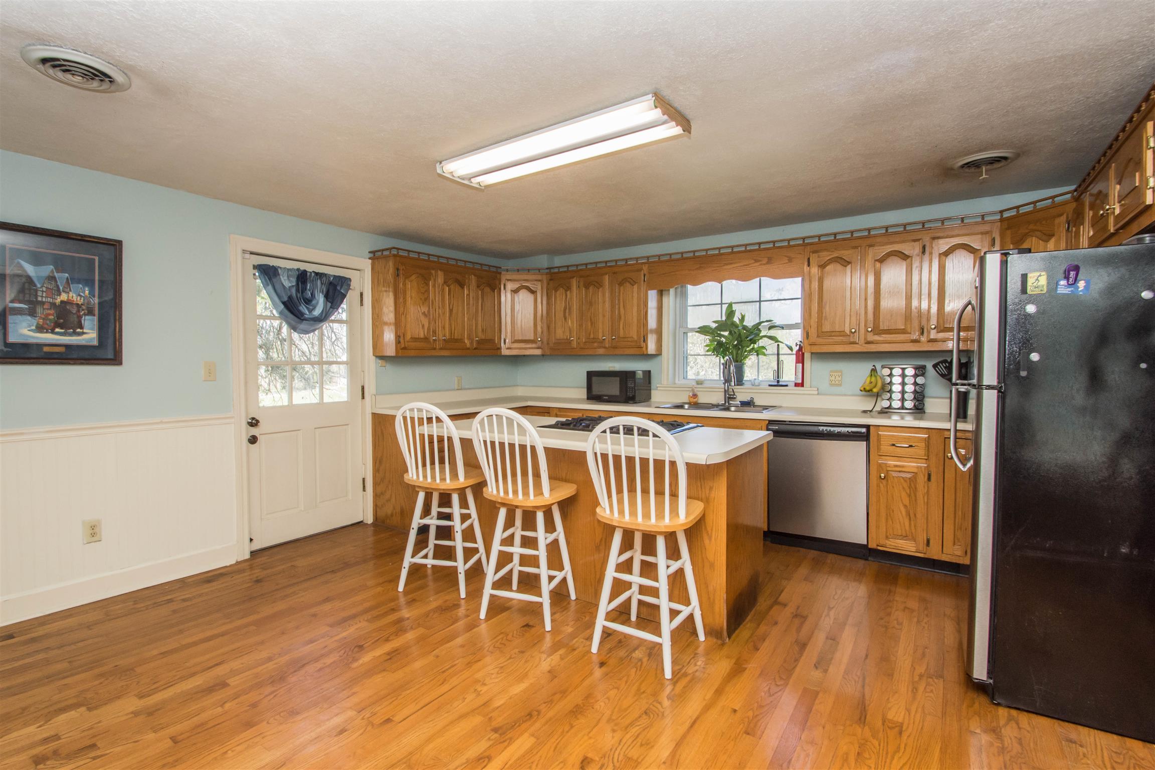 1810 Bend Road Clarksville, TN 37040 - Photo 7 of 17 a kitchen with stainless steel appliances a dining table chairs refrigerator and sink