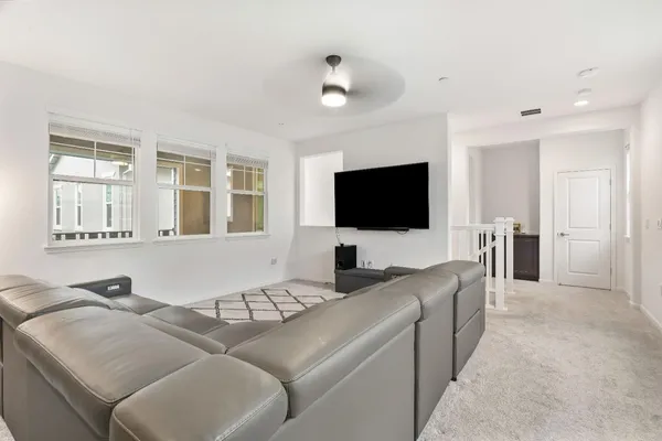 a living room with furniture and kitchen view