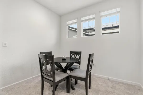 a view of a dining room with furniture and window