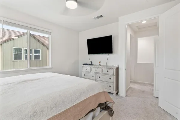 a bedroom with a bed and cabinets
