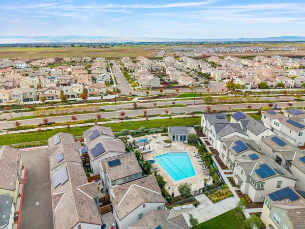 an aerial view of a house with a garden and lake view