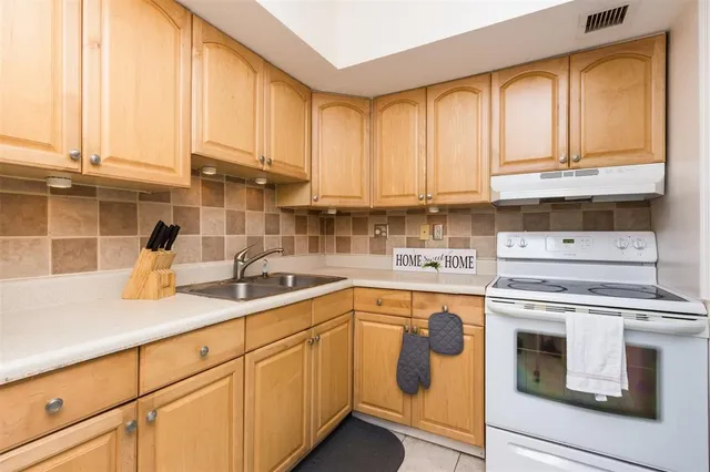 a kitchen with appliances cabinets and a sink
