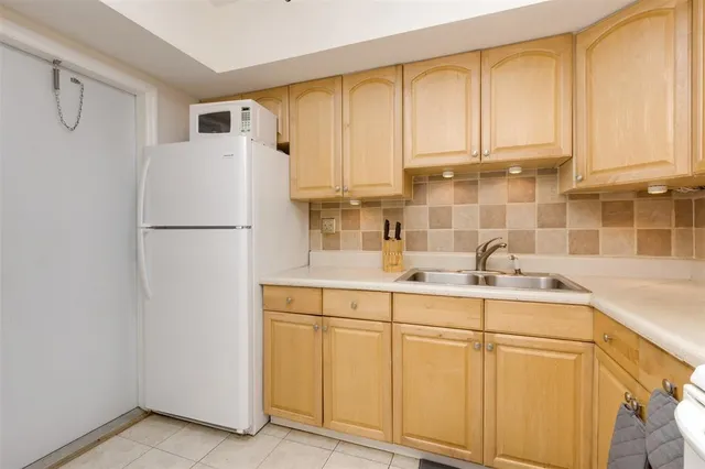 a kitchen with appliances cabinets and furniture