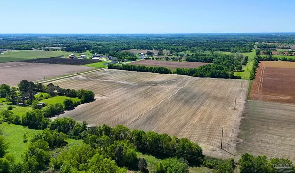 an aerial view of a house with a yard and lake view