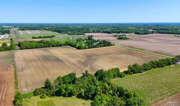 an aerial view of a house with a yard and lake view