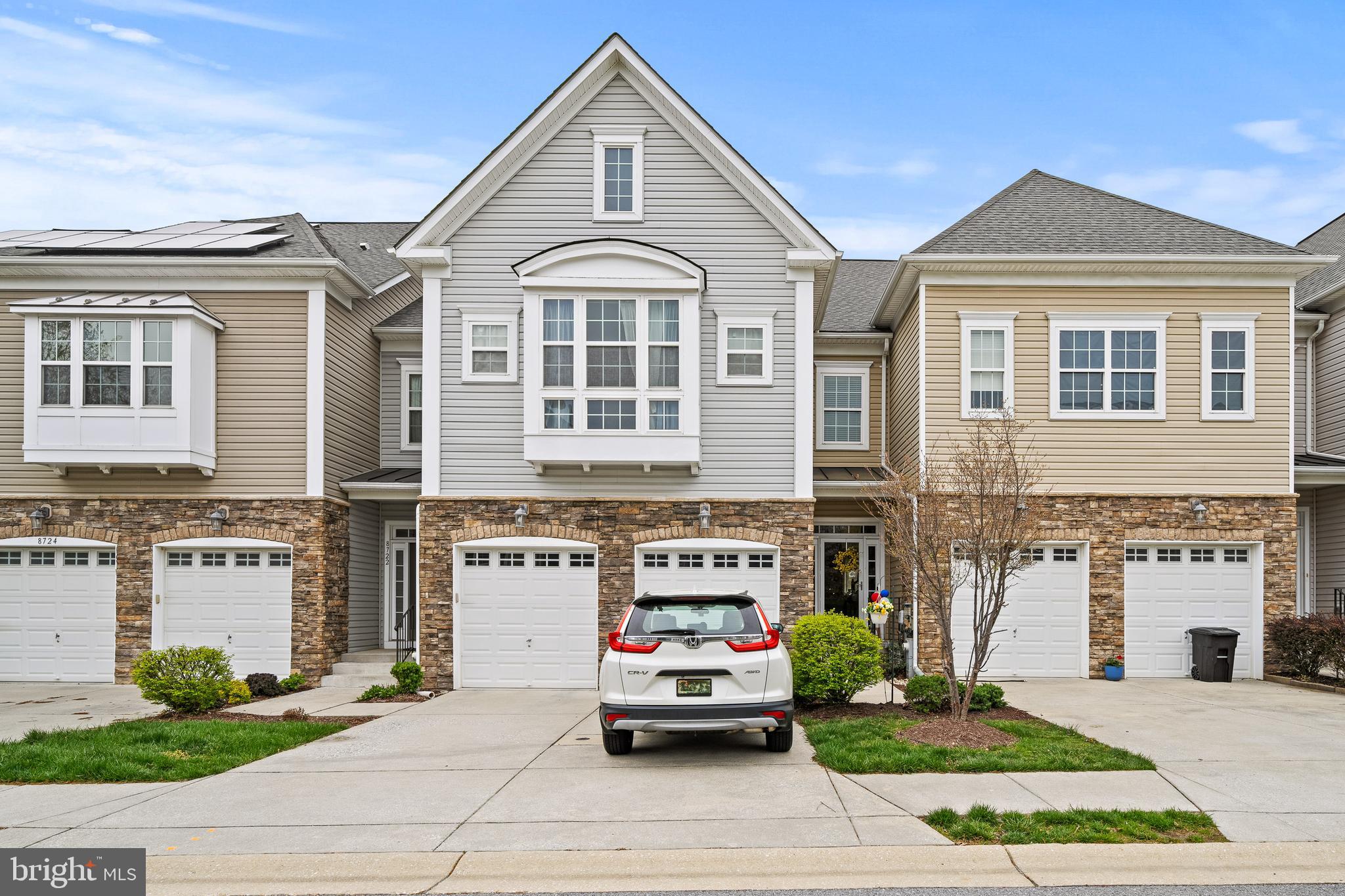 8722 Polished Pebble Way Laurel, MD 20723 - Photo 1 of 58 a front view of a residential apartment building with a yard