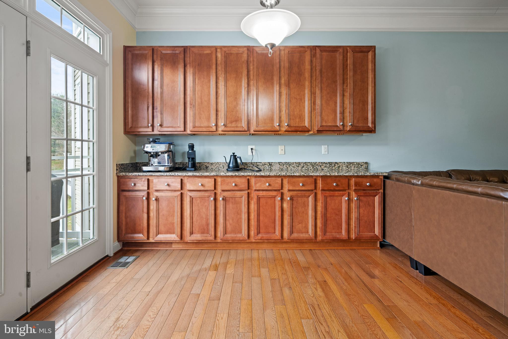 8722 Polished Pebble Way Laurel, MD 20723 - Photo 11 of 58 a view of a kitchen with wooden floor and cabinets