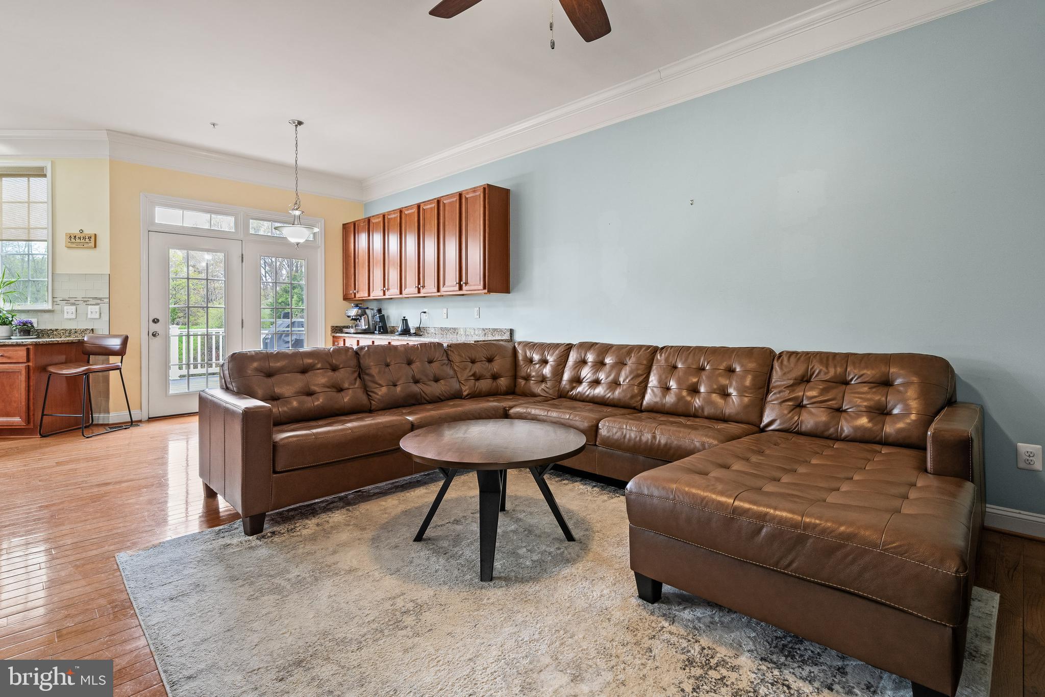 8722 Polished Pebble Way Laurel, MD 20723 - Photo 12 of 58 a living room with a couch and a wooden floor