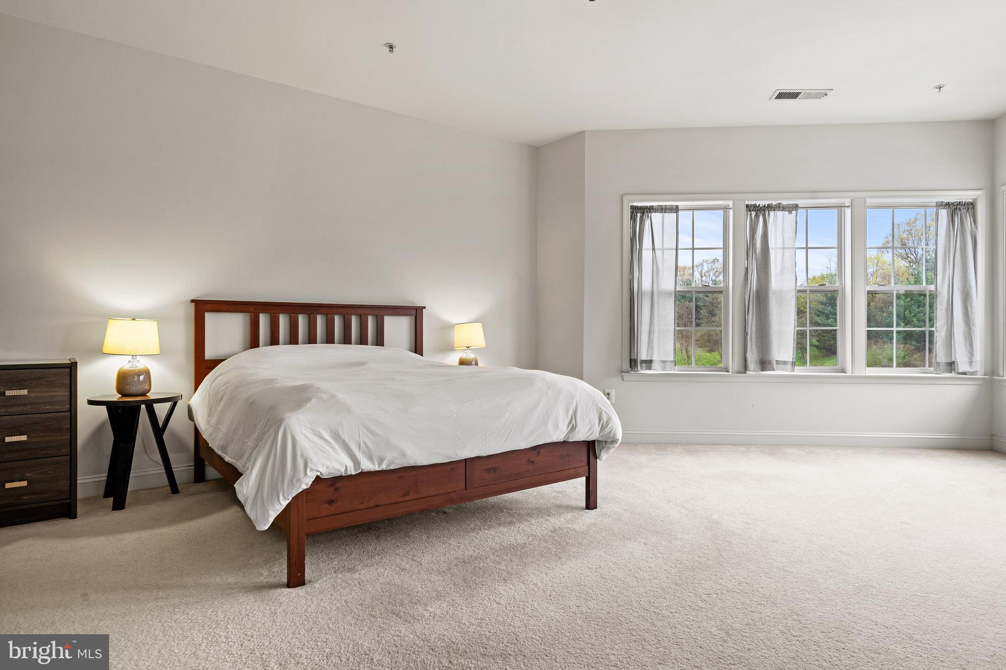 8722 Polished Pebble Way Laurel, MD 20723 - Photo 16 of 58 a spacious bedroom with a bed and a large window