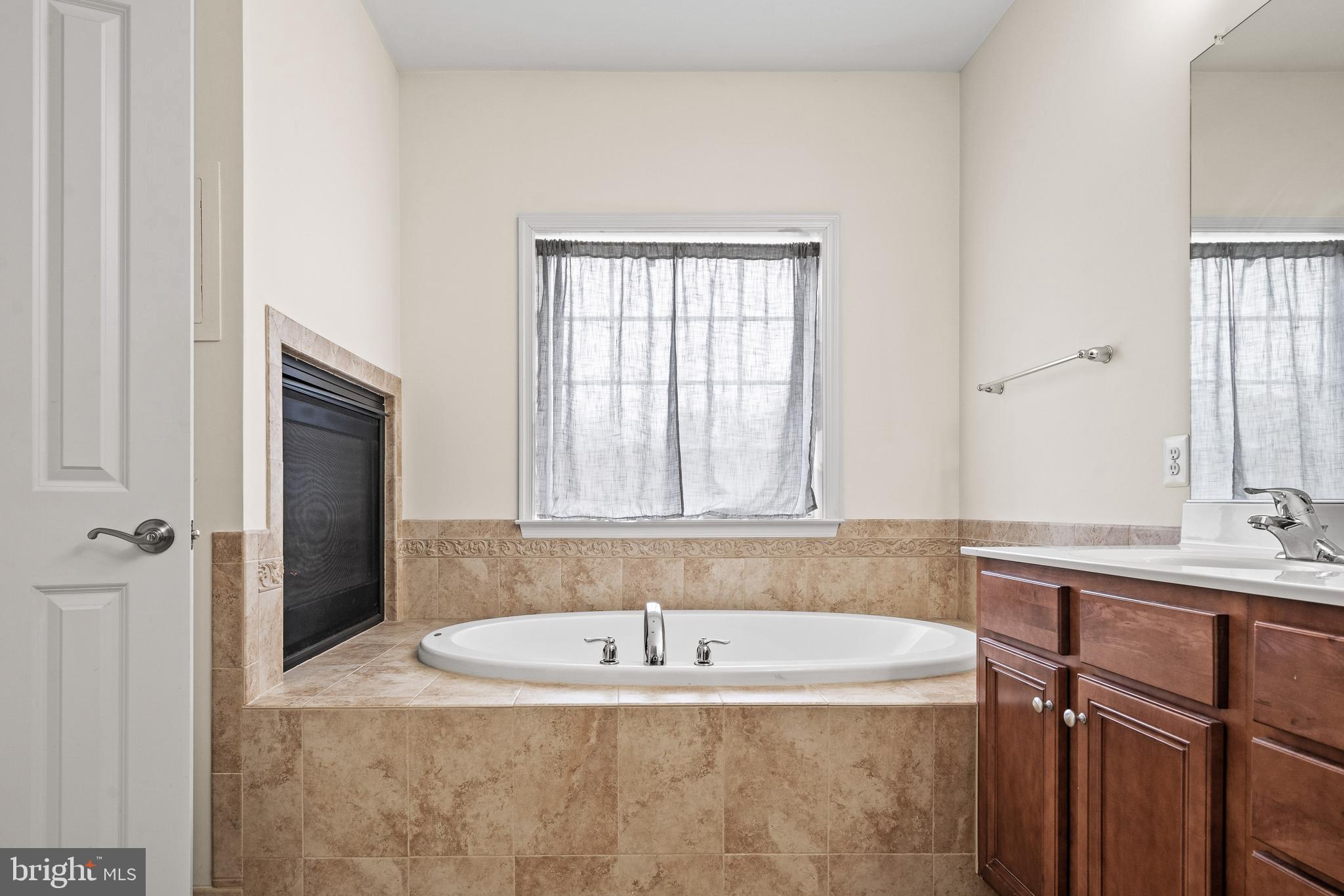 8722 Polished Pebble Way Laurel, MD 20723 - Photo 22 of 58 a bath tub sitting in a bathroom next to a window