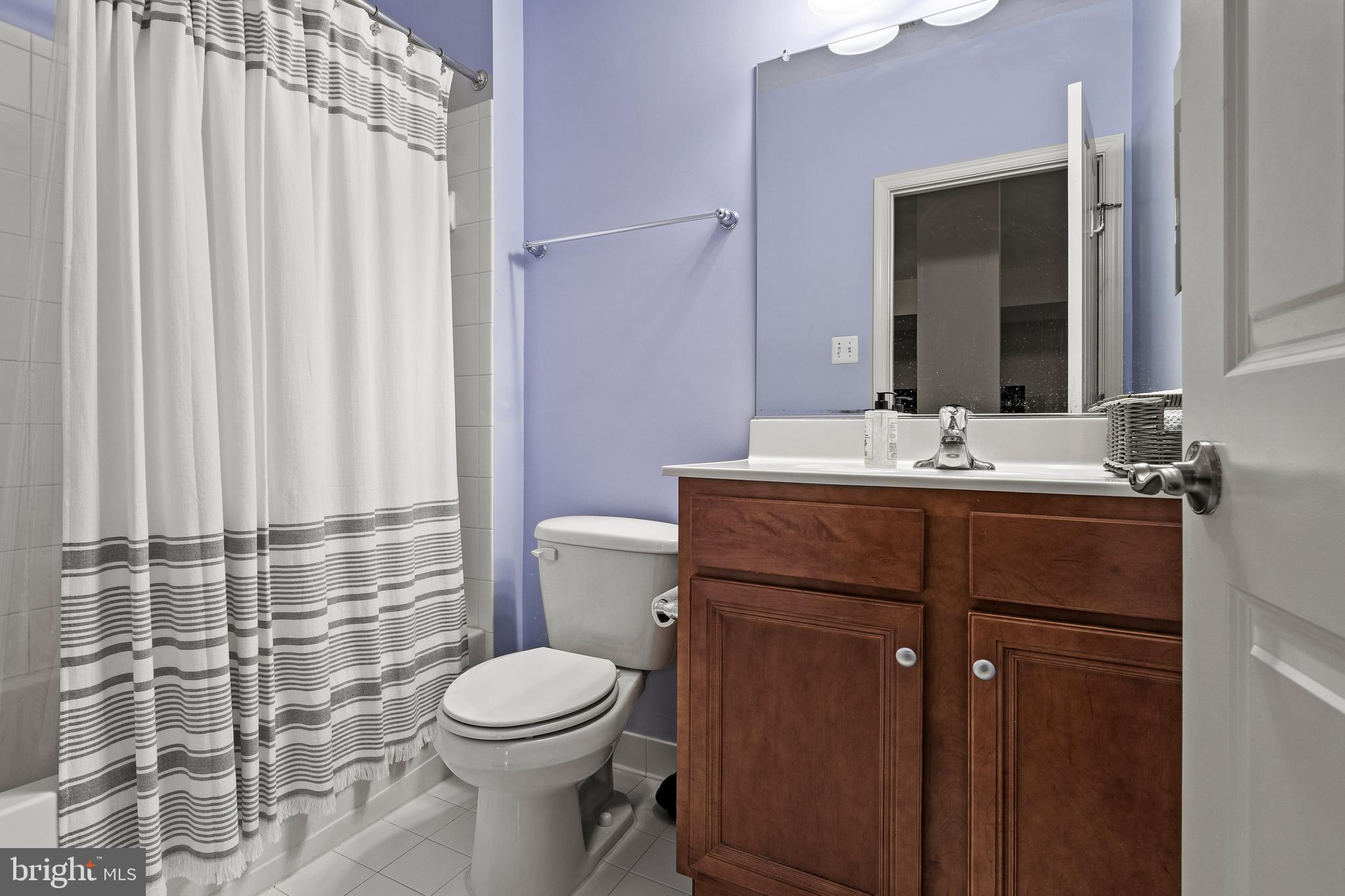 8722 Polished Pebble Way Laurel, MD 20723 - Photo 29 of 58 a bathroom with a sink a toilet and shower
