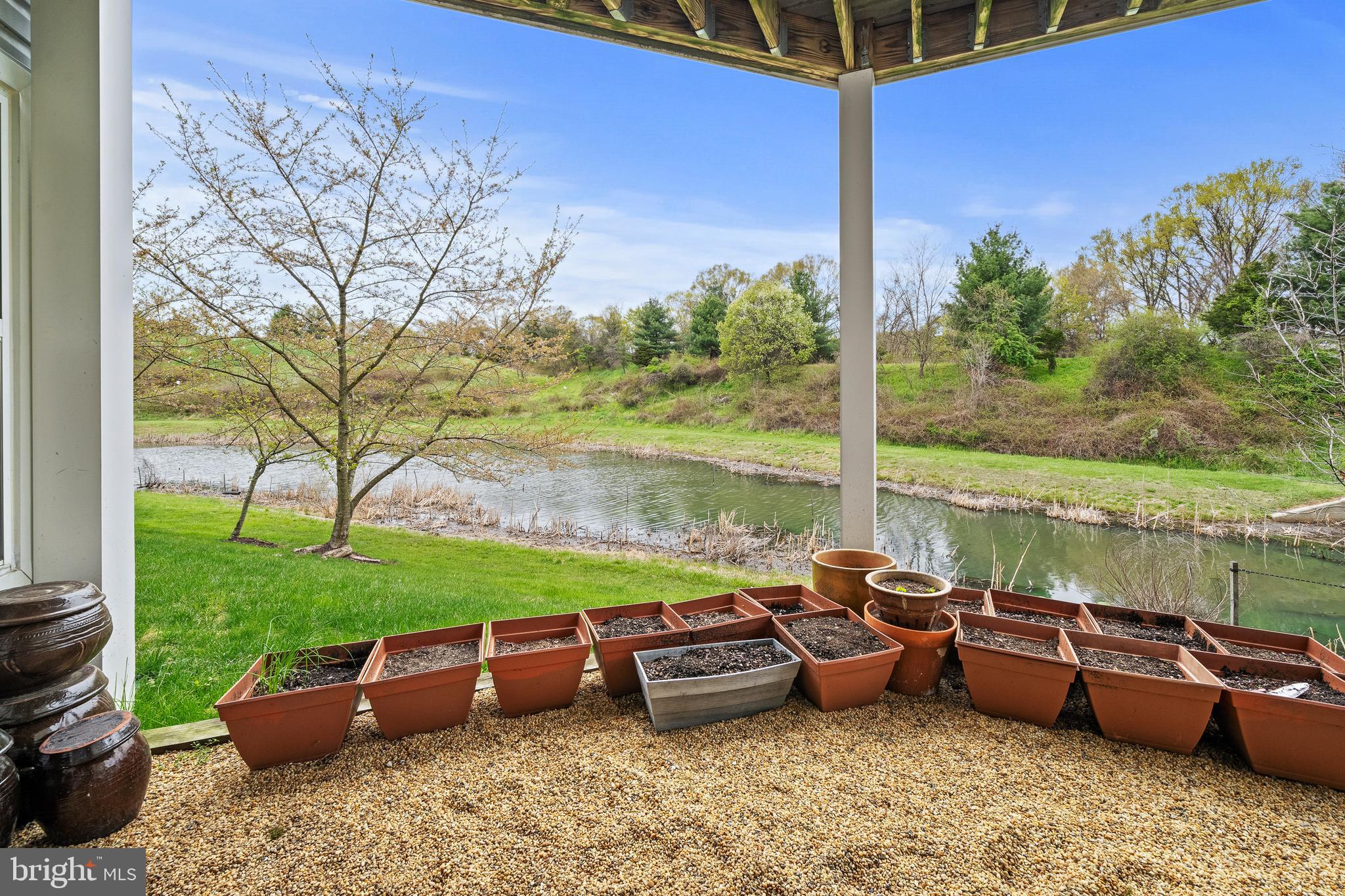 8722 Polished Pebble Way Laurel, MD 20723 - Photo 3 of 58 a view of a garden with lawn chairs and a fire pit