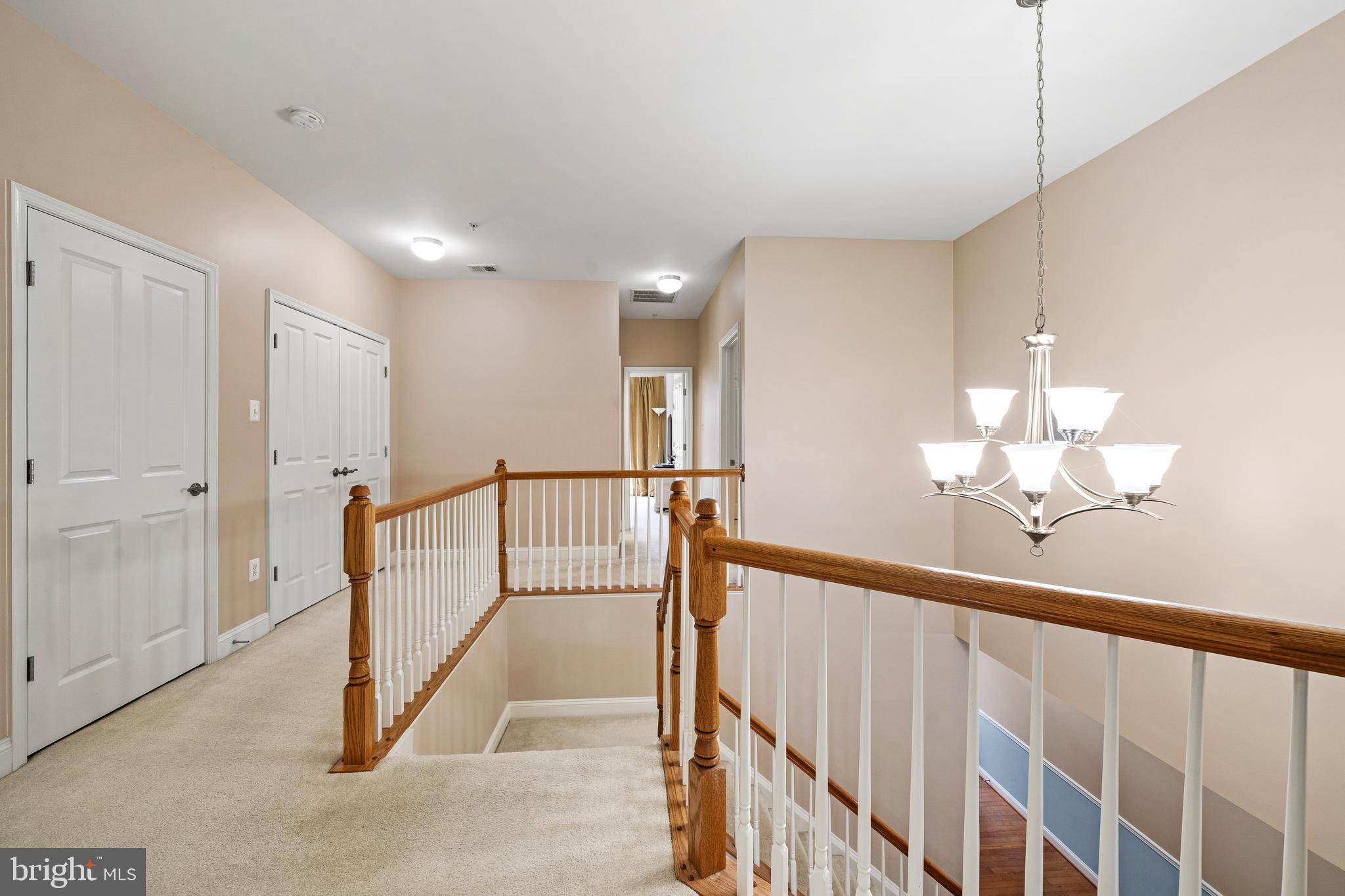 8722 Polished Pebble Way Laurel, MD 20723 - Photo 31 of 58 a view of a hallway with a chandelier