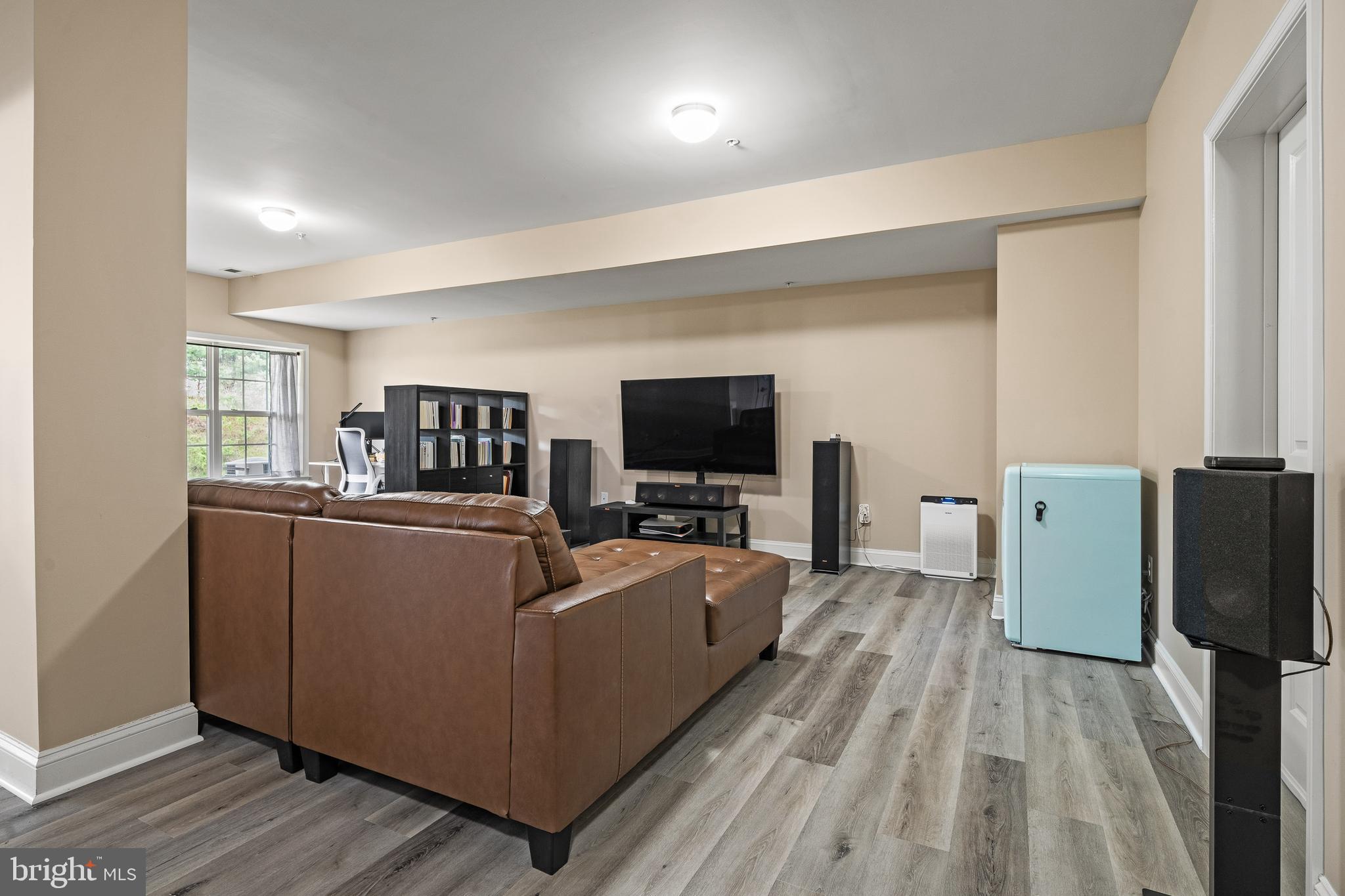 8722 Polished Pebble Way Laurel, MD 20723 - Photo 32 of 58 a living room with furniture a flat screen tv and a refrigerator