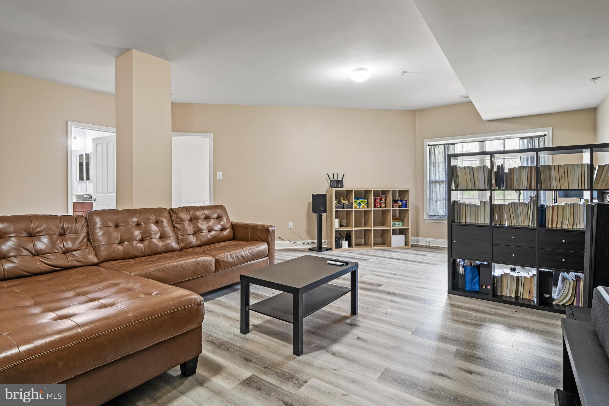 8722 Polished Pebble Way Laurel, MD 20723 - Photo 34 of 58 a living room with furniture and a book shelf