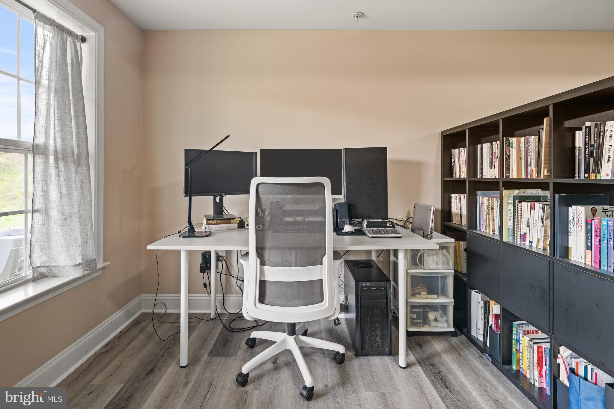 8722 Polished Pebble Way Laurel, MD 20723 - Photo 35 of 58 a view of a workspace with furniture and a book shelf