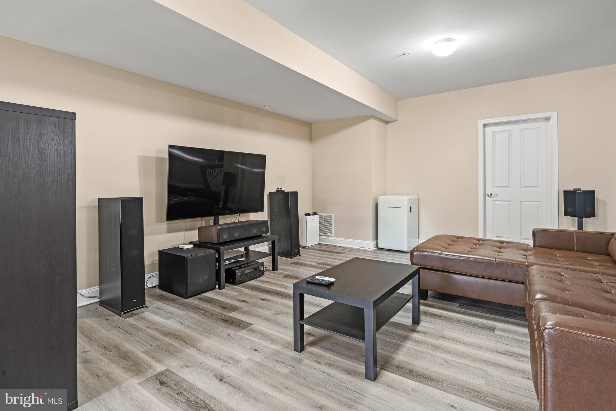 8722 Polished Pebble Way Laurel, MD 20723 - Photo 36 of 58 a living room with furniture and a flat screen tv