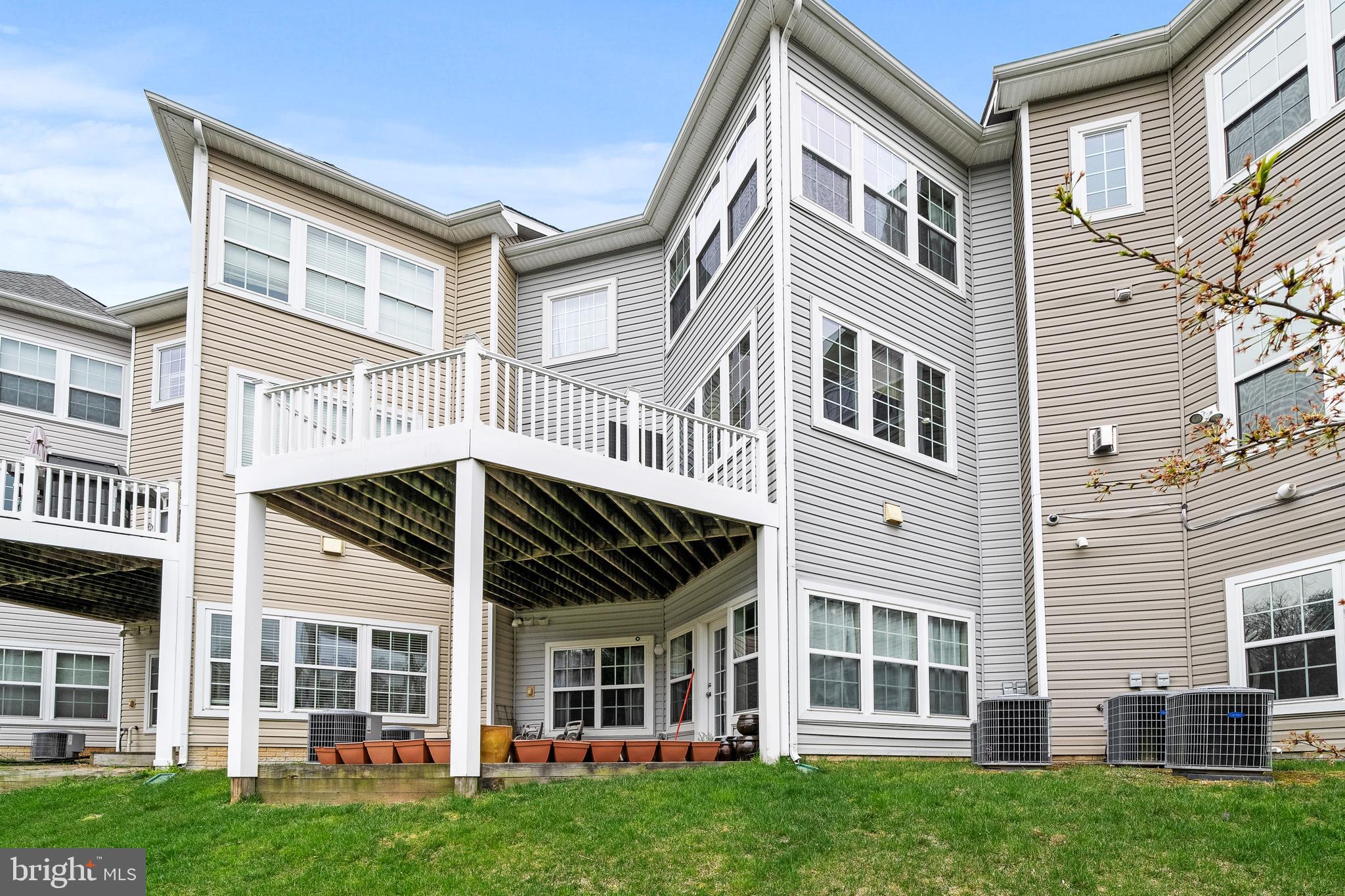 8722 Polished Pebble Way Laurel, MD 20723 - Photo 39 of 58 a view of a large white building next to a yard
