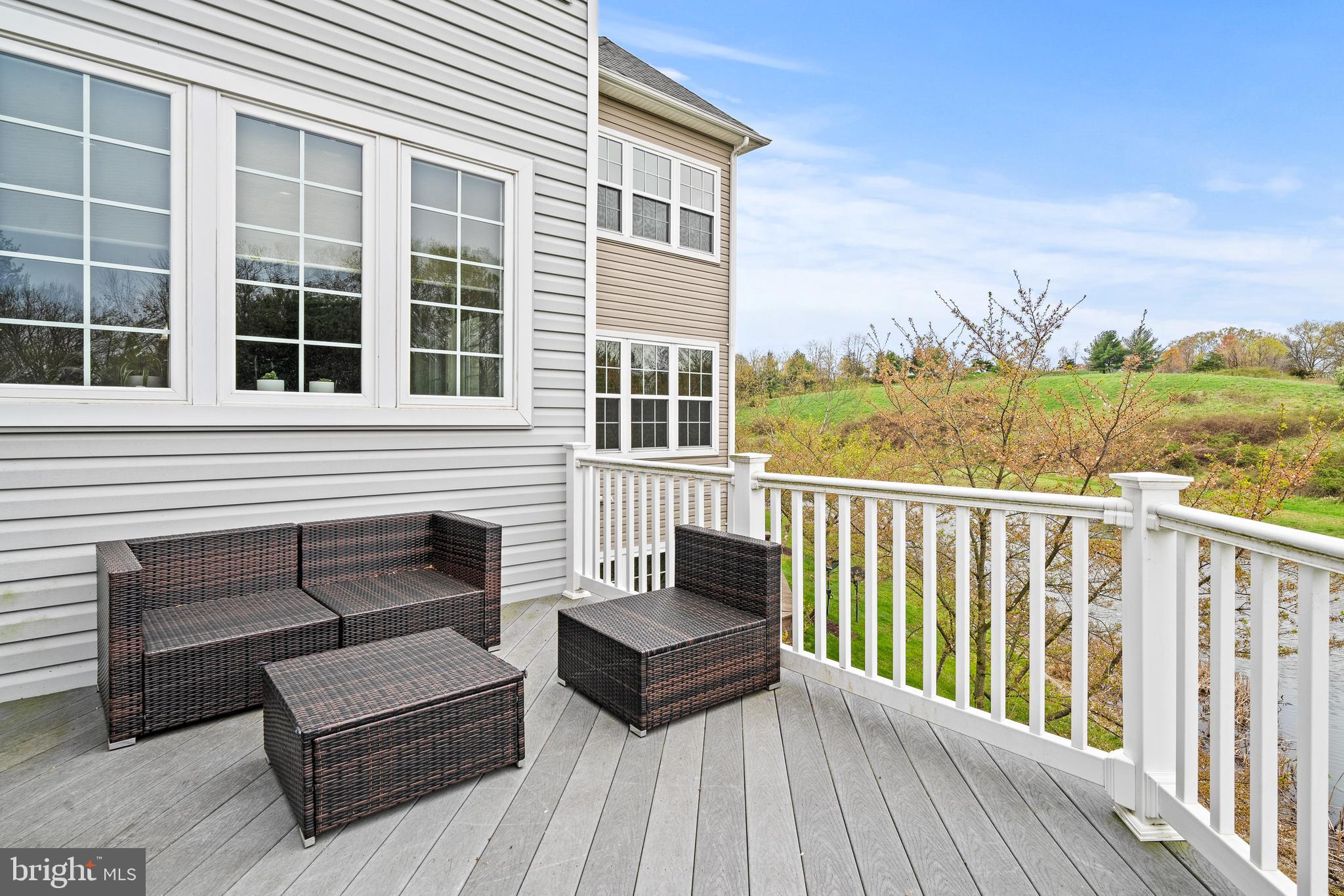 8722 Polished Pebble Way Laurel, MD 20723 - Photo 4 of 58 a view of a roof deck with couches and wooden floor