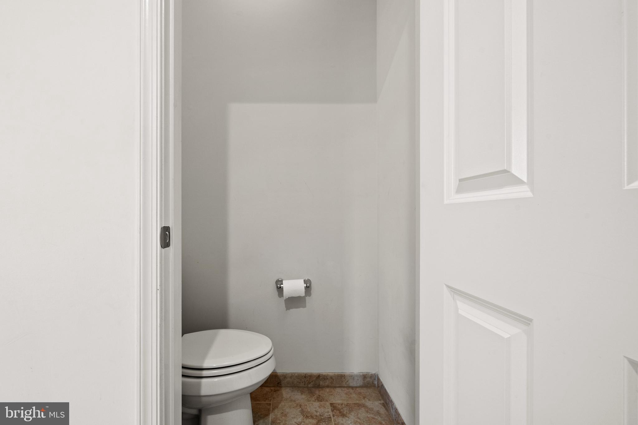 8722 Polished Pebble Way Laurel, MD 20723 - Photo 42 of 58 a white toilet sitting next to a shower