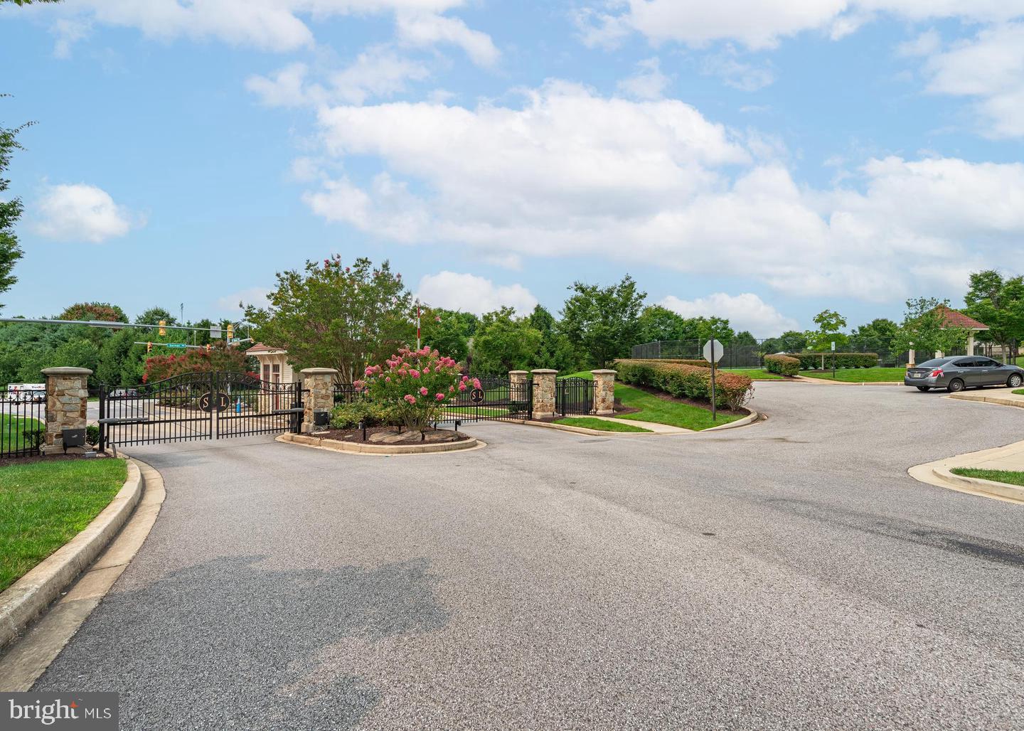 8722 Polished Pebble Way Laurel, MD 20723 - Photo 45 of 58 a view of a road with a yard