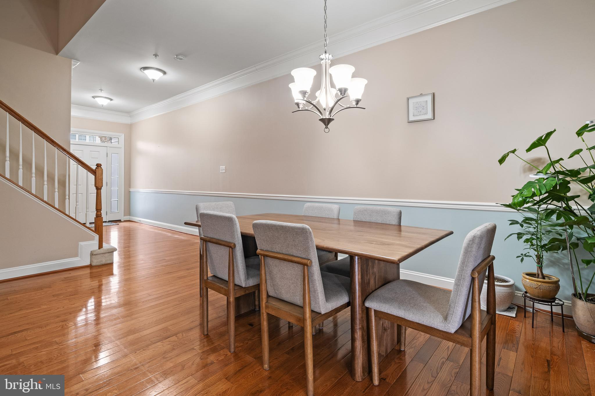 8722 Polished Pebble Way Laurel, MD 20723 - Photo 9 of 58 a view of a dining room with furniture wooden floor and chandelier